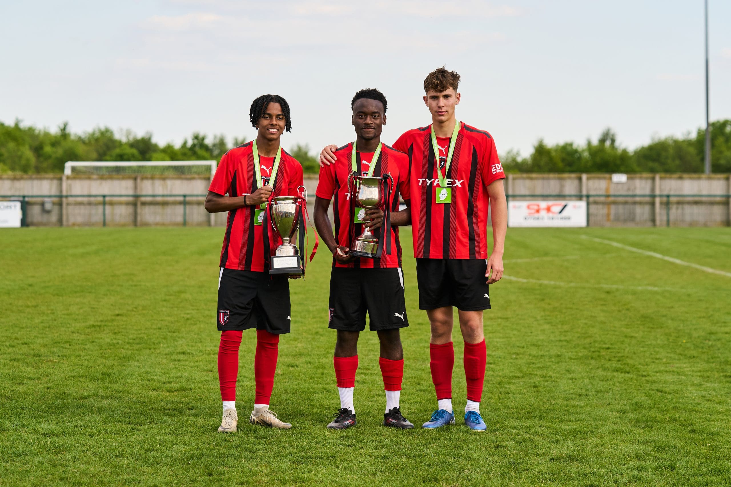 FCV Grace Dieu Players holding league and cup trophies